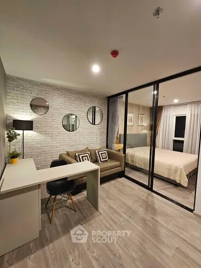 Modern studio apartment with stylish decor and glass partitioned bedroom