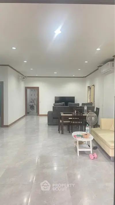 Spacious living room with modern furniture and open layout, perfect for family gatherings.