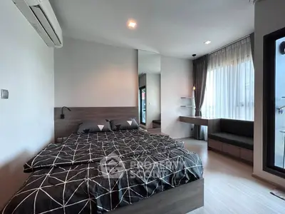 Modern bedroom with stylish decor and large windows offering natural light