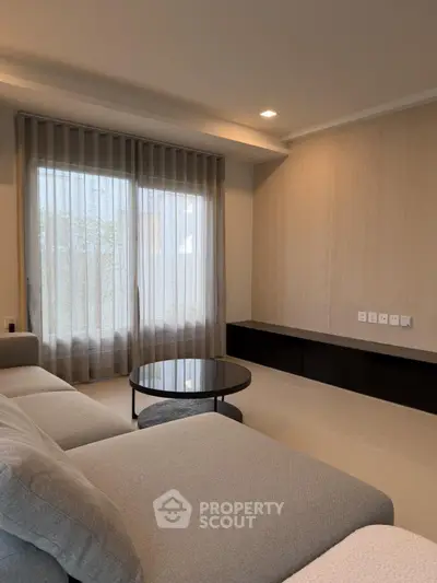 Modern living room with sleek design and cozy gray sofa, perfect for relaxation and entertainment.