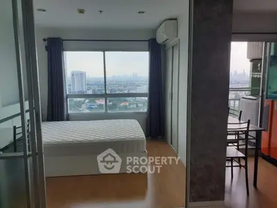 Modern bedroom with large window offering stunning city views and natural light