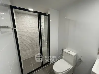 Modern bathroom with sleek shower and contemporary toilet design.