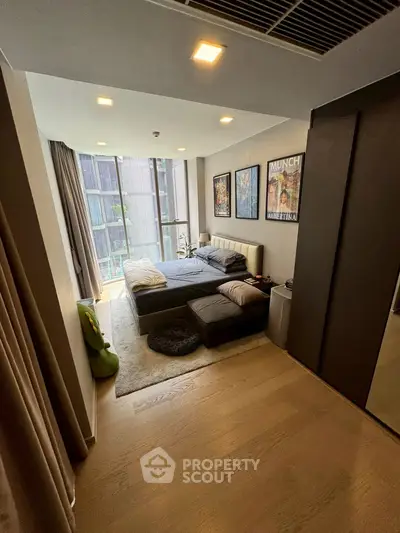 Modern bedroom with floor-to-ceiling windows and stylish decor