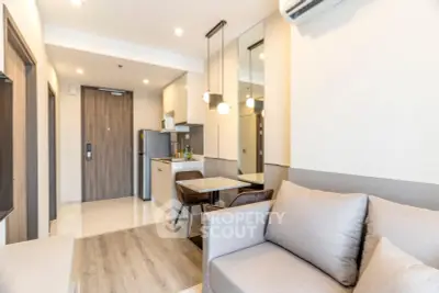 Modern living room with open kitchen and stylish decor in a cozy apartment.