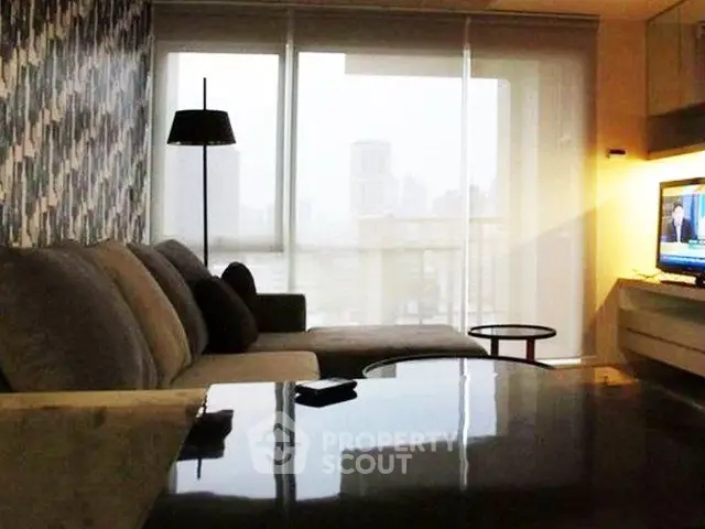 Modern living room with city view, stylish decor, and cozy seating area.