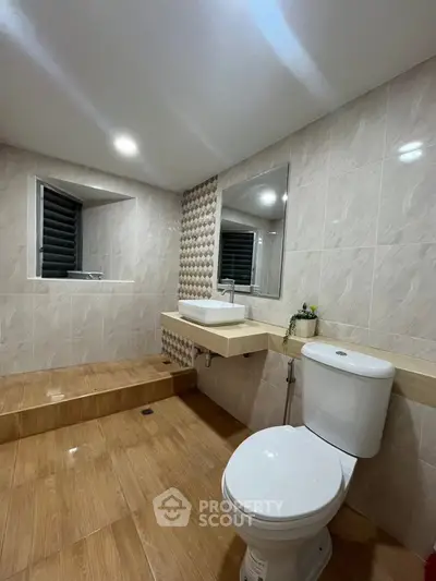 Modern bathroom with sleek design and elegant tiling.