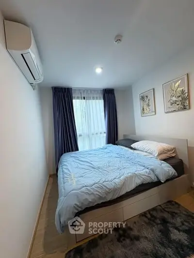 Cozy bedroom with modern decor and natural light, featuring a comfortable bed and stylish artwork.
