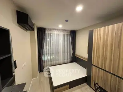 Modern bedroom with stylish wooden furniture and large window with curtains