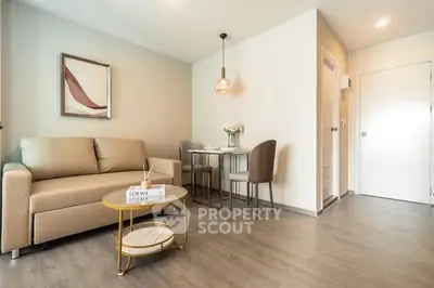 Modern living room with cozy sofa and dining area in stylish apartment.