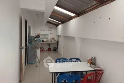Cozy dining area with natural light and simple furnishings in a compact space.