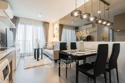 Modern living room with dining area, stylish lighting, and cozy decor in a contemporary apartment.