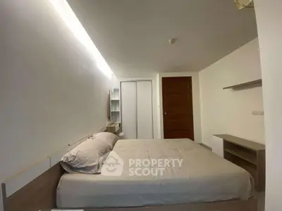 Modern minimalist bedroom with sleek design and ample storage space.