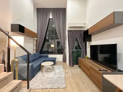 Modern living room with high ceilings, stylish furniture, and large windows for natural light.