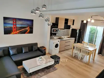 Modern open-plan living room with sleek kitchen and stylish decor
