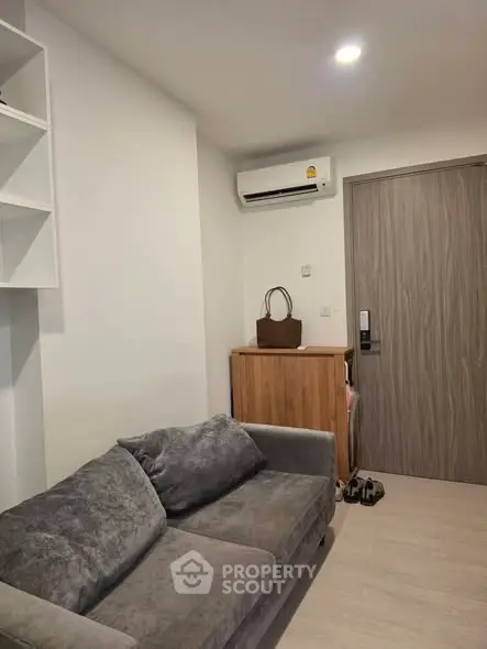 Cozy living room with modern sofa and air conditioning in a stylish apartment.