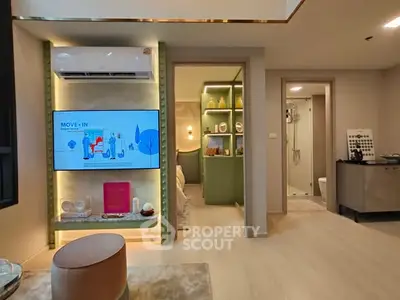 Modern living room with stylish decor and open view into bedroom and bathroom