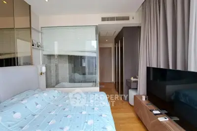 Modern bedroom with stylish decor and large window for natural light