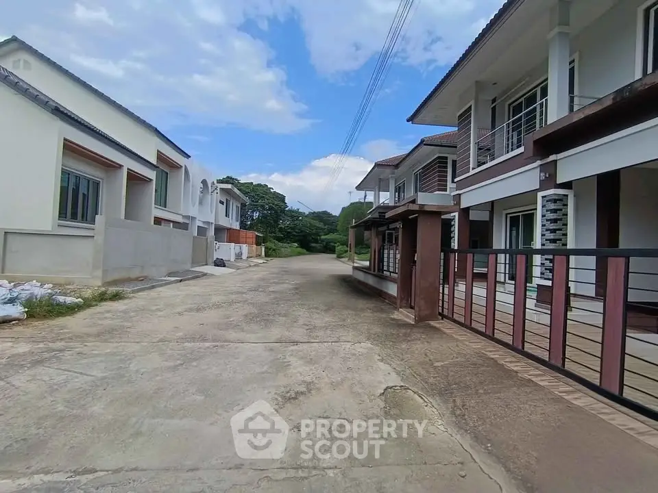 Charming suburban street with modern two-story homes and lush greenery, perfect for family living.
