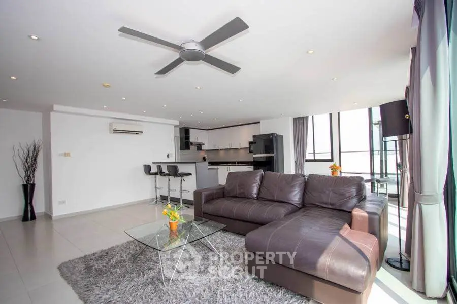 Spacious modern living room with open kitchen and stylish decor