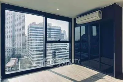 Modern apartment with large windows offering stunning city views and sleek air conditioning unit.