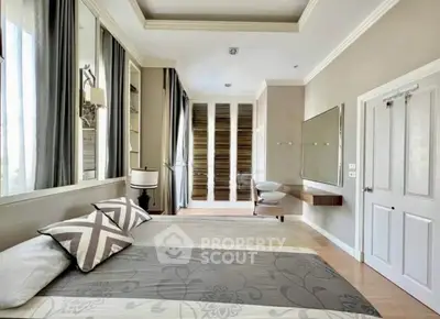 Luxurious bedroom with elegant decor and ample natural light