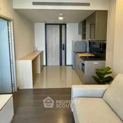 Modern apartment interior with compact kitchen and cozy living area