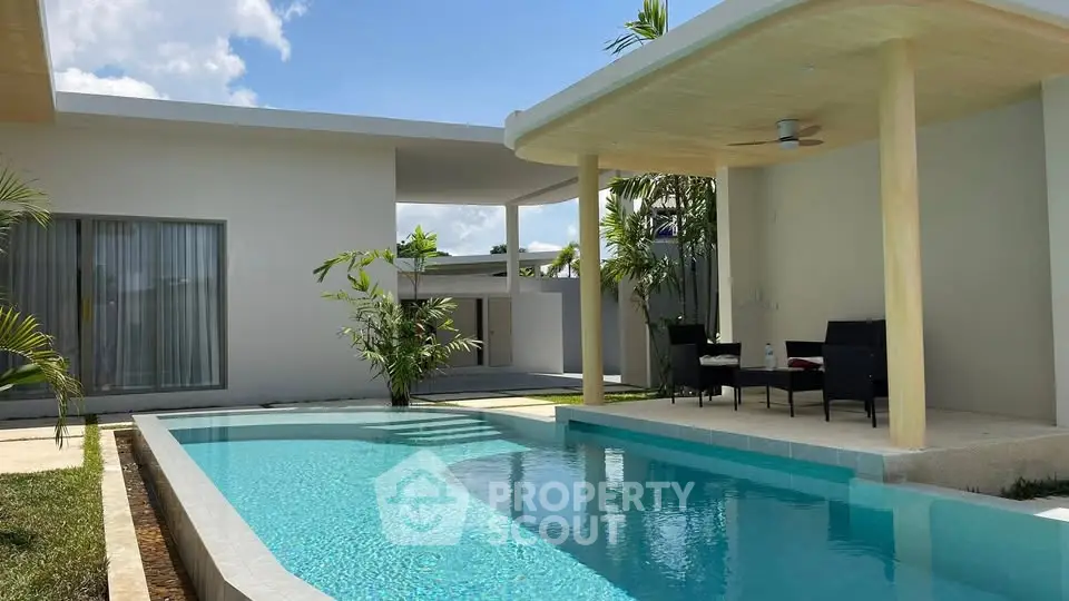 Luxurious modern villa with private pool and stylish outdoor seating area, perfect for relaxation and entertainment.