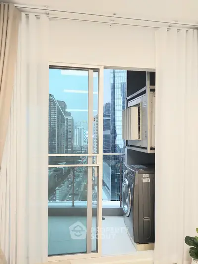 Modern apartment balcony with city view and washing machine