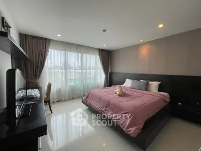 Spacious modern bedroom with large window and elegant decor