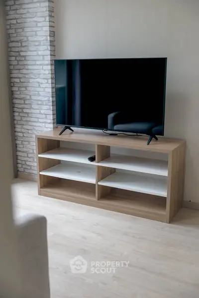 Modern living room with sleek TV stand and flat-screen television