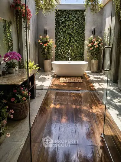 Luxurious open-air bathroom with freestanding tub and lush greenery, perfect for a serene retreat.