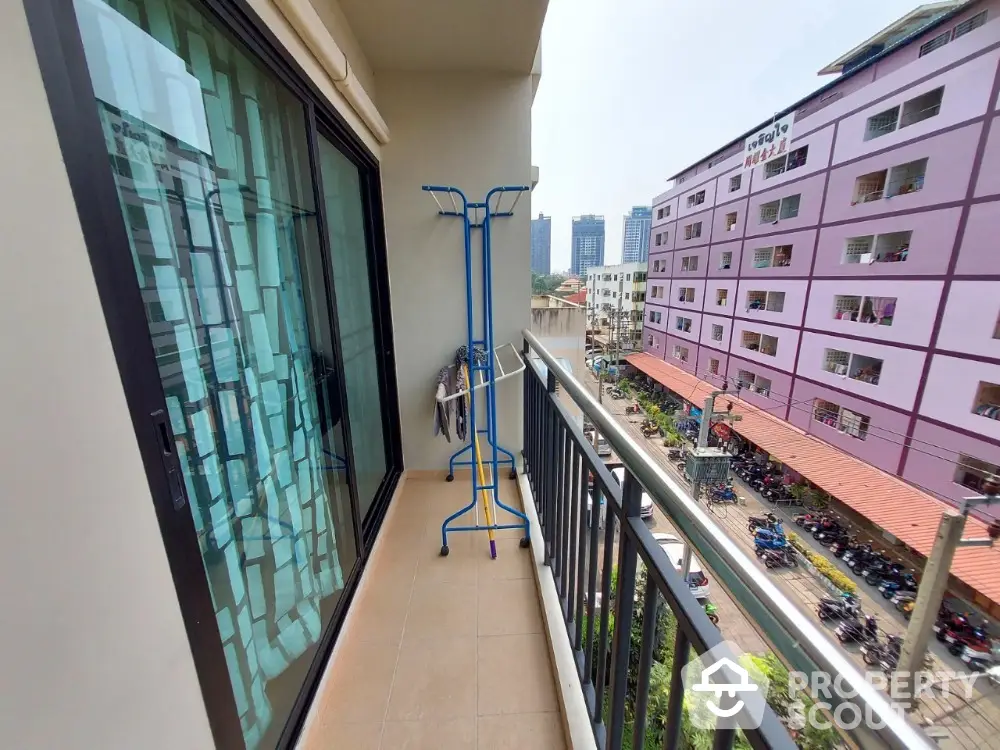 Spacious balcony with city view in modern apartment building