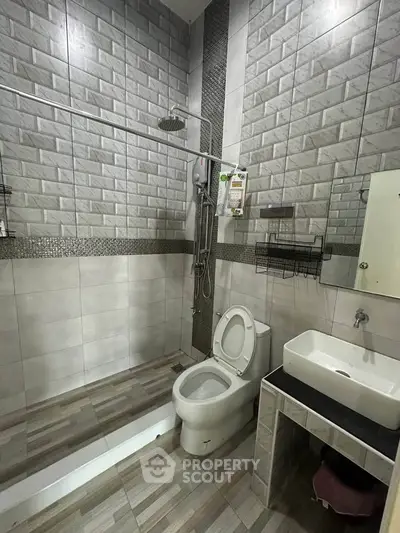 Modern bathroom with sleek tile design and open shower layout