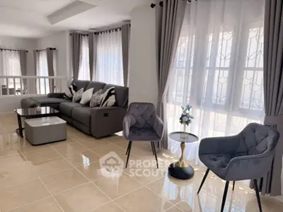 Spacious modern living room with elegant furniture and large windows