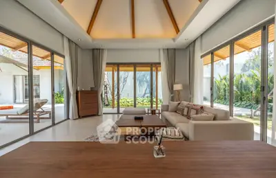 Luxurious living room with large windows and garden view in modern villa