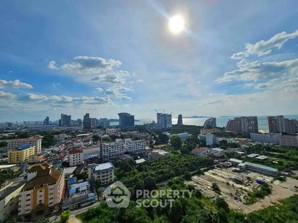 Stunning cityscape view with lush greenery and skyline under a bright sun.