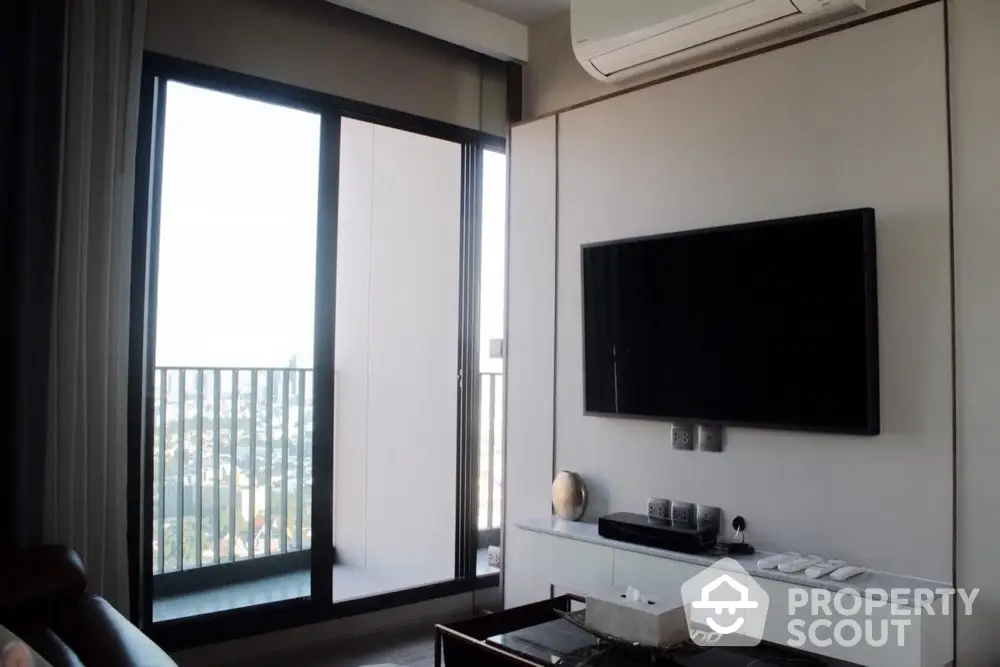 Modern living room with balcony view and wall-mounted TV