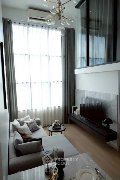 Modern living room with high ceilings and elegant decor in a luxury apartment.