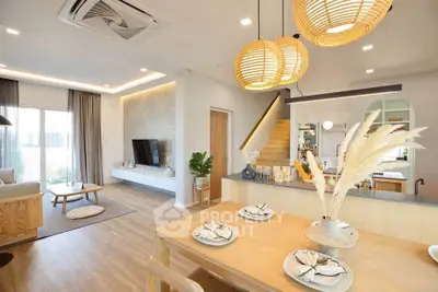 Modern open-plan living and dining area with stylish decor and natural light.