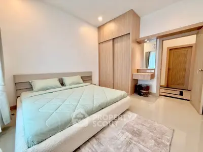 Modern bedroom with stylish wooden accents and cozy bedding in a contemporary apartment.