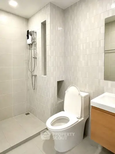 Modern bathroom with sleek tiles and contemporary fixtures in a stylish real estate property.