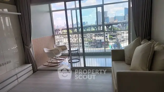 Modern living room with large windows and city view, featuring cozy seating and a stylish balcony.