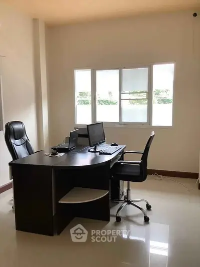Modern study room with sleek desk and ergonomic chairs, ideal for productivity and comfort.