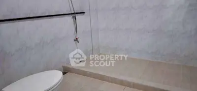 Spacious bathroom with modern shower and tiled walls, ideal for comfort and style.