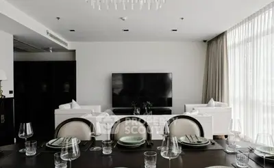 Luxurious modern living room with elegant dining setup and large TV