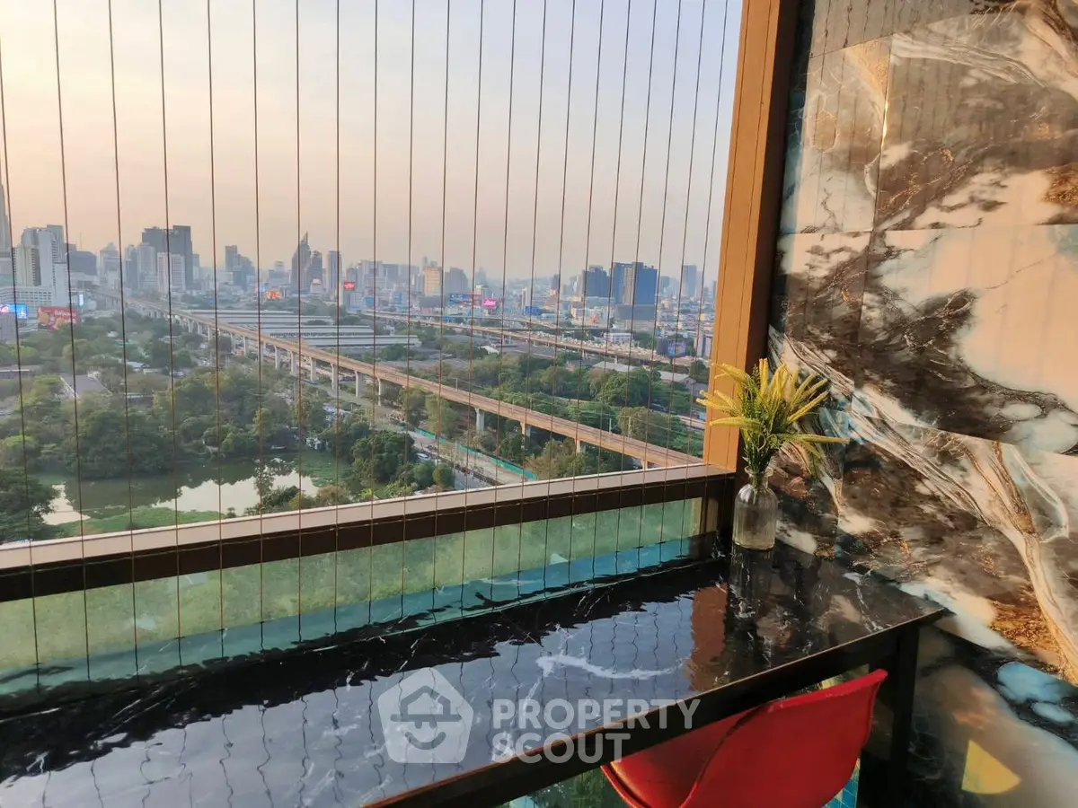 Stunning cityscape view from a modern balcony with sleek marble accents and stylish decor.
