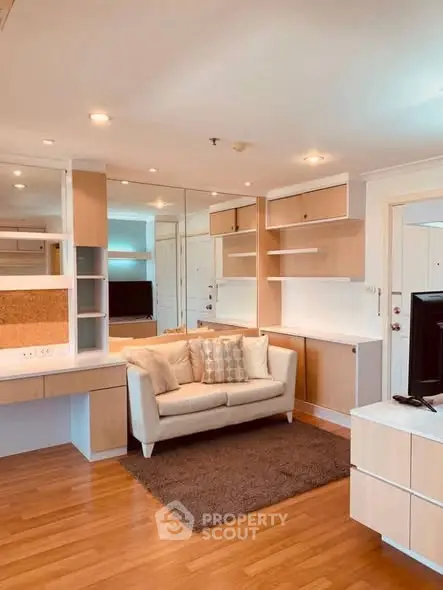 Modern living room with stylish shelving and cozy sofa in a bright apartment.