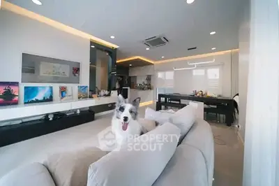 Spacious modern living room with open kitchen and cozy seating area, perfect for relaxation and entertainment.