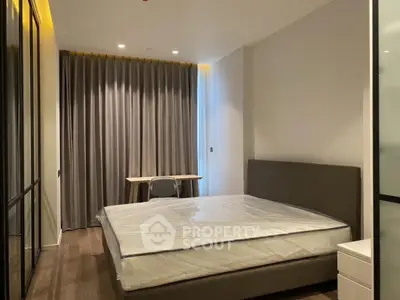 Modern bedroom with sleek design and large window, featuring a comfortable bed and stylish furniture.