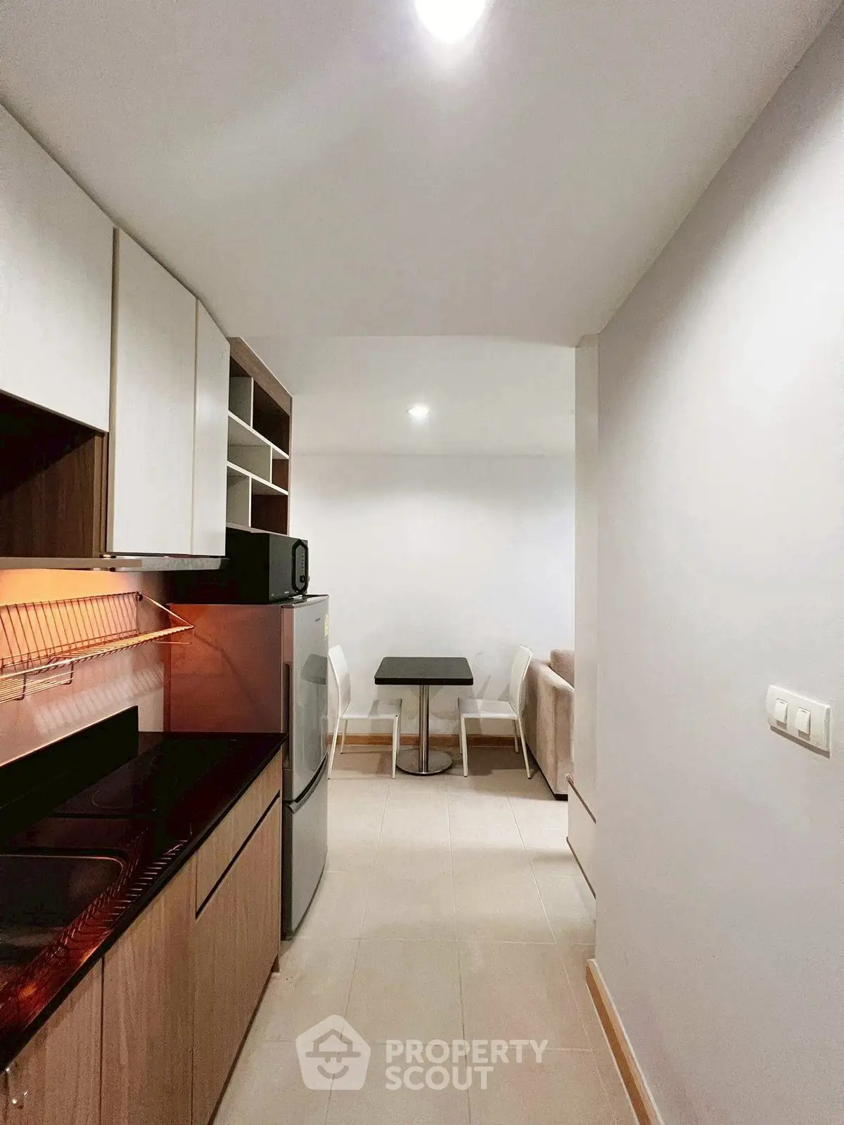 Modern compact kitchen with dining area in cozy apartment